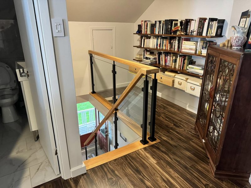 Garde-corps de verre et main courante de bois autour d'une trémie d'escalier